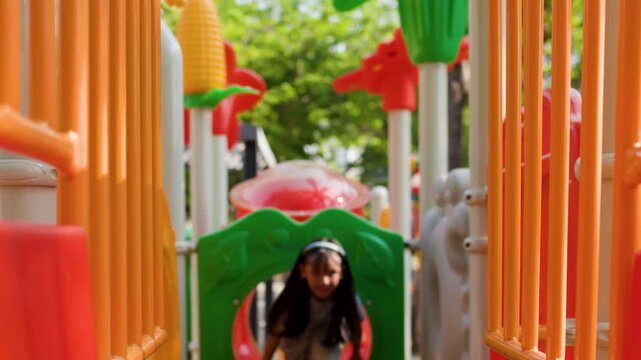 Young Asian Girl Playing on Colorful Playground Equipment in Lumpini Park