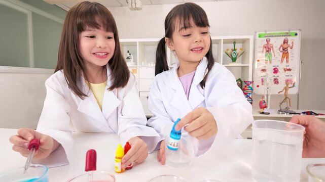 Primary School Girls Conducting Colorful Science Lab Experiment