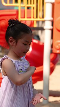 Young Thai Girl Playing Rock Paper Scissors at Lumpini Park Playground