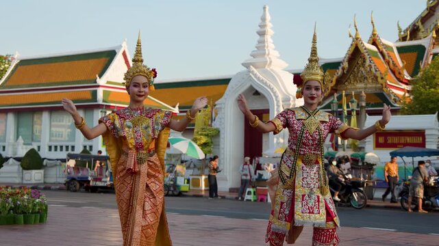 Traditional Thai Dancers Performing in Front of Wat Suthat Temple