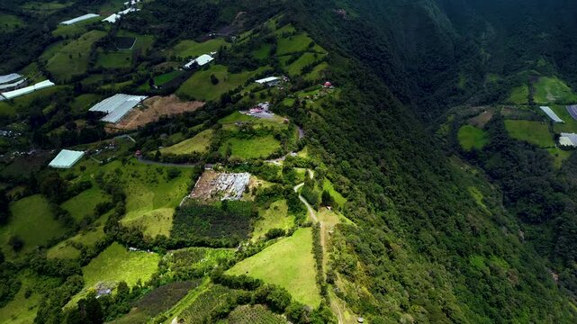Aerial View of Steep Green Mountain Valley in Ecuador with Farms, Forested Slopes and Remote Rural Andean Landscape Background