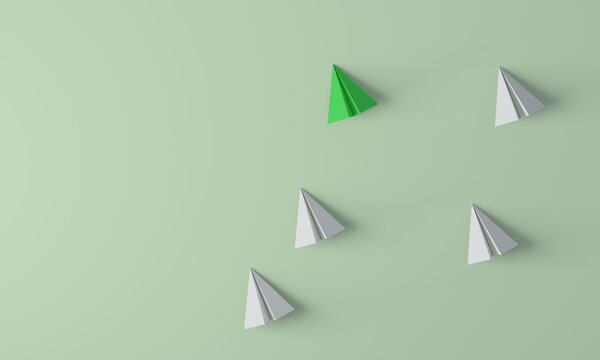 Green paper plane leading white paper planes