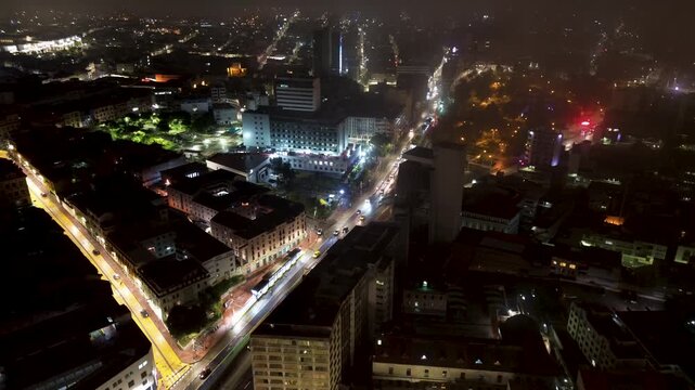 Aerial Night View of Quito Ecuador Avenue and City Lights, Curving Road, High Rise Buildings and High Altitude Urban Landscape