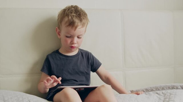 Portrait of a baby using a device for online learning or entertainment.