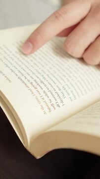 Close-up of hands holding an open book.