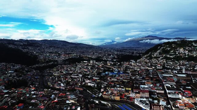 Wide Aerial View of Quito Ecuador Skyline with Dense City Buildings, Mountain Basin, Blue Clouds and High Altitude South American Urban Travel Landscape