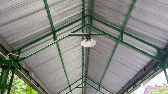 Close up view of industrial canopy roof structure with green metal frames