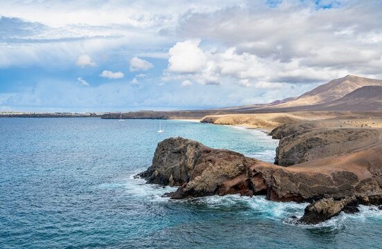 Sandy beach beach and rocky coast with dramatic sky, Playa de Papagayo, coastal landscape, Los Ajaches Natural Park, Lanzarote, Canary Islands, Spain