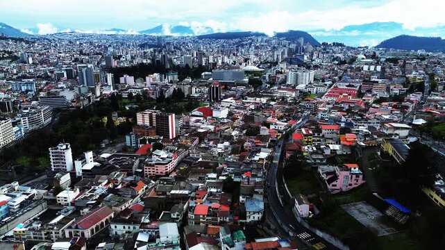 Wide Aerial View of Quito Ecuador City with Green Hills, Dense Buildings, Roads and Mountain Basin, High Altitude South American Urban Landscape