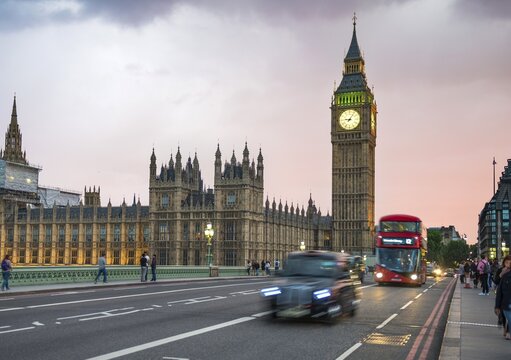 Taxi and red double-decker bus on the Westminster Bridge, Big Ben and Westminster Palace, motion blur, sunset, London, England, Great Britain