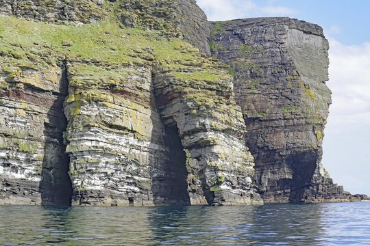Dramatic cliffs with geological stratification over the sea, Isle of Noss, Shetland Islands, Scotland, Great Britain