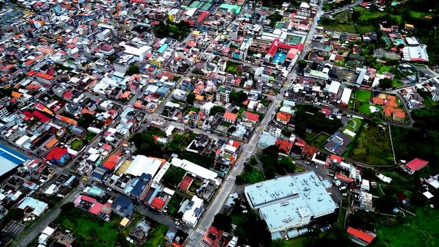 Drone View of Dense Quito Ecuador Neighborhood with Red Rooftops, Urban Streets, Hillside Buildings and High Altitude South American Cityscape