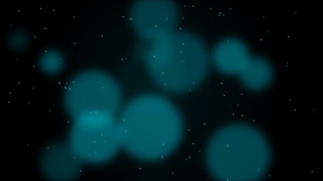 Abstract teal bokeh lights and soft dust particles floating on black background