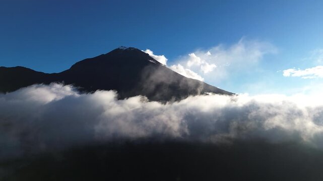 Volcano Peak Rising Above Clouds in Ecuador Andes, Dark Mountain Silhouette, Blue Sky and Scenic High Altitude Nature Travel Landscape