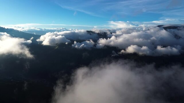 Dramatic Clouds Over Ecuador Andes Mountains with Dark Forested Slopes, Blue Sky and High Altitude Wilderness Travel Landscape Background