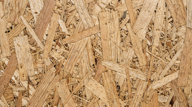 Natural textured surface of oriented strand board panel made of compressed wood flakes with osb panel building material construction material