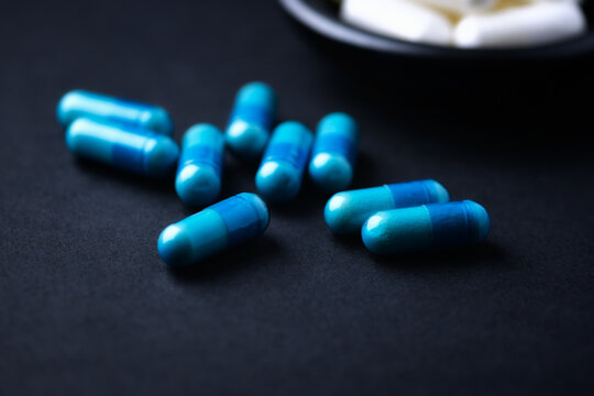 Amino acids capsules on paper background. Soft focus. Close up
