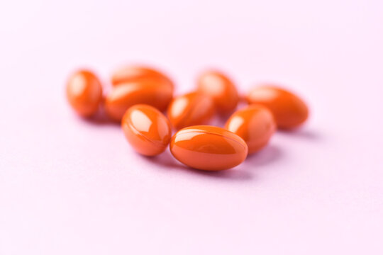 Lutein capsules. Dietary supplement on bright paper background. Soft focus. Close up. Copy space.
