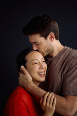 Obraz premium Affectionate man kissing his Korean wife.