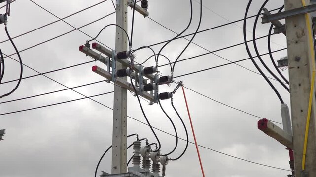 Close up video of operating a high voltage disconnect switch with a fiberglass hot stick, industrial electrical power grid distribution network maintenance.