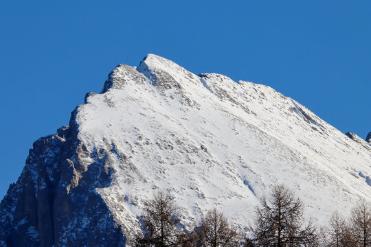 Rugged mountain ridges and pristine snowfields define this winter scene in the Italian Alps