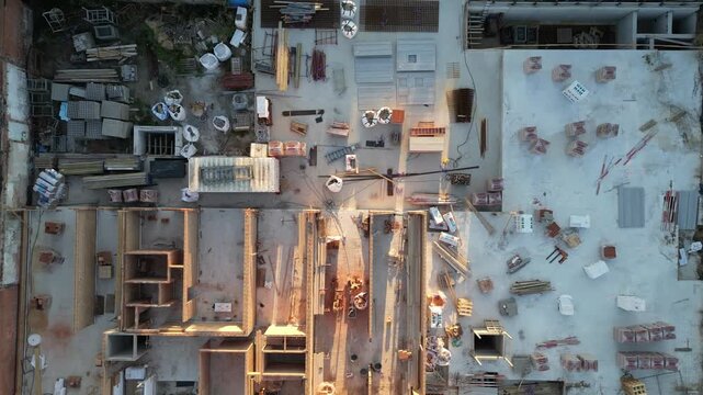 Cinematic Drone Footage Ascending Over a New Building Construction Site at Sunset