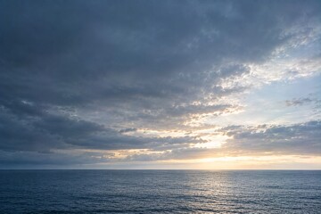 Obraz premium Dark Storm Clouds Clearing Over Calm Ocean
