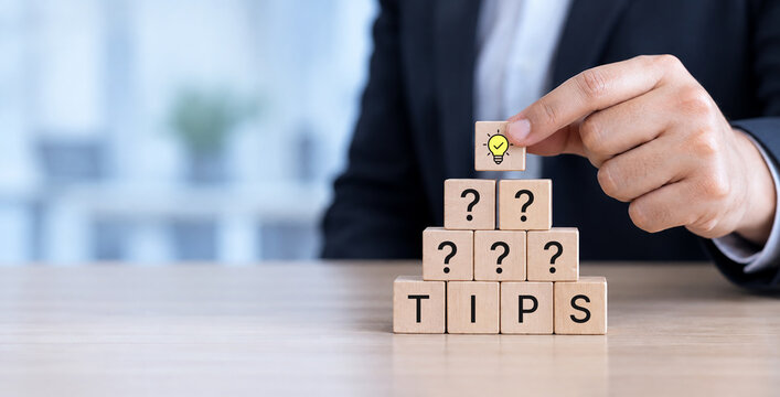 Quick Tips for Smart Solutions. A lightbulb icon block and wooden cubes spelling &ldquo;TIPS". Simple advice, smart ideas and practical guidance and daily work, advice and idea for business, advertising.