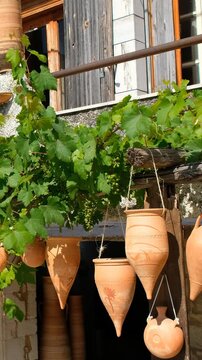 Vertical video of different pottery at the entrance to the local workshop. Crete. Greece.