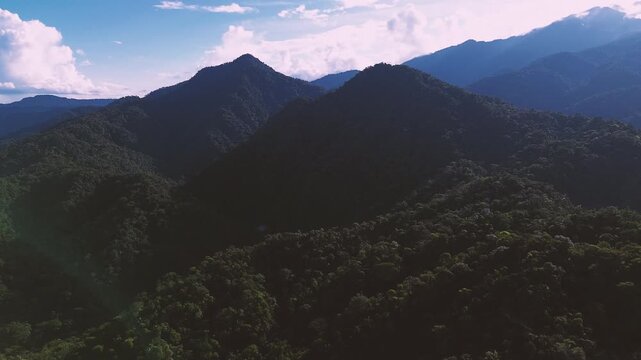Dramatic Aerial View of Ecuador Rainforest Mountain Ridges with Dark Slopes, Blue Haze, Cloudy Sky and Remote Andean Amazon Wilderness