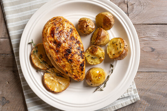 Oven roasted lemon garlic chicken and baby potatoes on plate