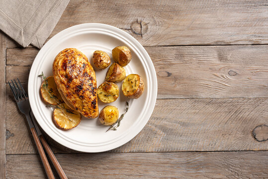 Oven roasted lemon garlic chicken and baby potatoes on plate