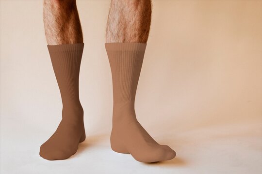 Pair of brown compression socks on male legs