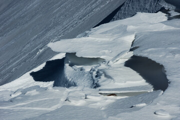 Snow cornices along the snow-covered ridge of the Alpine peaks Pizzo Baciamorti and Monte Araralta. Orobie Alps, Italy. © Gherzak