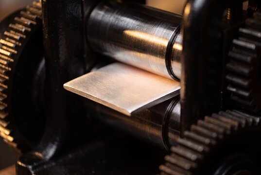 Close Up of Heavy Industrial Metal Rolling Machine Processing Copper Sheet