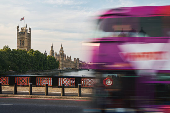 London bus passing Palace of Westminster with motion blur