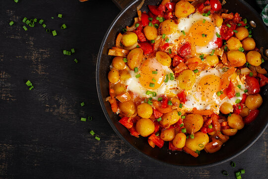 Shakshuka Style Eggs with Potatoes and Sweet Peppers. Top view, above