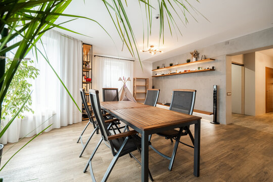 Wooden dining table with metal frame and mesh chairs