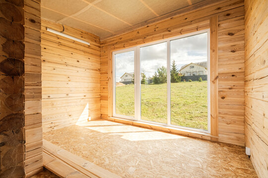 Log cabin interior with wide panoramic window