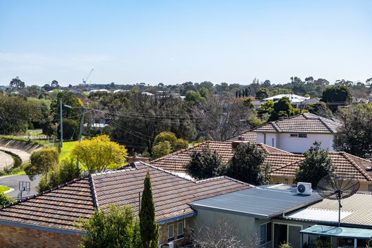 Elevated neighborhood overlooking the rooftops of older suburban residential homes in Yarraville,&nbsp;with tiled pitched roofs, satellite dishes. Melbourne Victoria Australia.