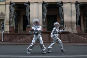 Cinematic scene with two astronauts aiming ray guns on a city street. Retro science fiction poster © Ulia Koltyrina