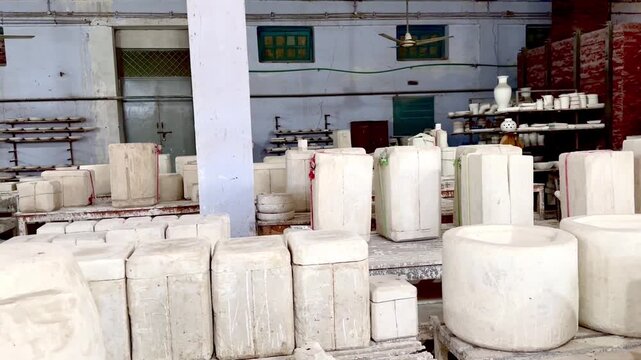 Ceramic and pottery manufacturing workshop with plaster molds and clay items