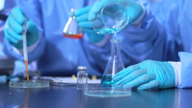 Lab work, scientists holds a test tube takes the test from a test tube in analysis for vaccine development.