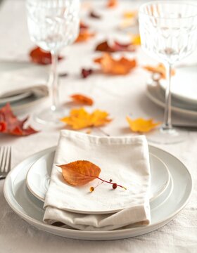 Elegant Autumn Table Setting with Napkin and Leaf Detail