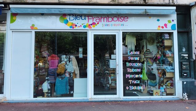 Royan, France - July 15, 2026: Charente-Maritime. Nouvelle-Aquitaine. Creative craft store front with colorful signage and window display showcasing various craft supplies and materials