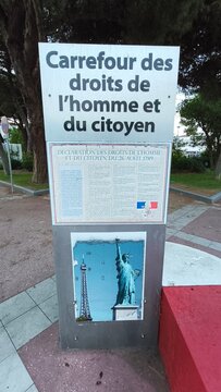 Royan, France - July 15, 2026: Charente-Maritime. Nouvelle-Aquitaine. Signpost for Carrefour des droits de l'homme et du citoyen with images of the Eiffel Tower and Statue of Liberty in park setting
