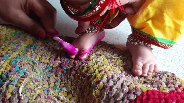 Traditional Indian Child Wearing Anklets and Red Alta on Colorful Handmade Rug