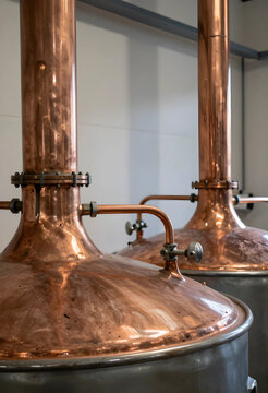 Craft distillery production, copper pot stills for alcohol distillation in a brewery or spirits manufacturing facility for artisanal beverage processing
