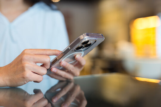 Close up of hands typing on modern smartphone device