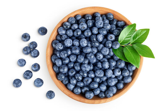 blueberry in wooden bowl isolated on white background. Top view. Flat lay